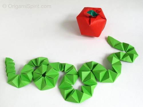Origami green snake and red apple