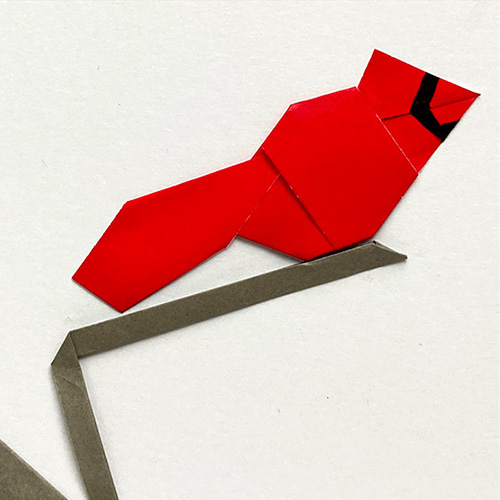Origami Model of a Strip Cardinal on a Branch designed by Leyla Torres & Hazel Burrows