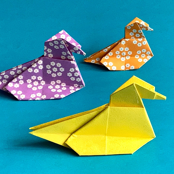 An origami model titled "Floating Duck" designed by Cliff Landesman