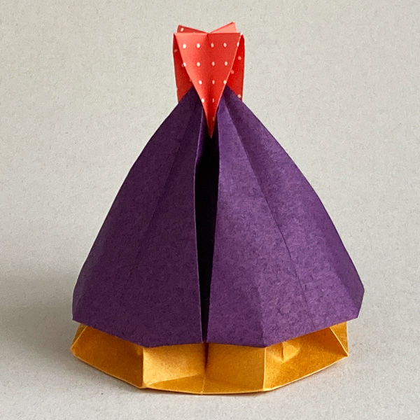 An origami model titled "Festive Bell Box" designed by Leyla Torres