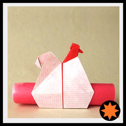 An Origami model titled "Messenger Hen," or, "Napkin Holder," or "Egg Holder," designed by Leyla Torres